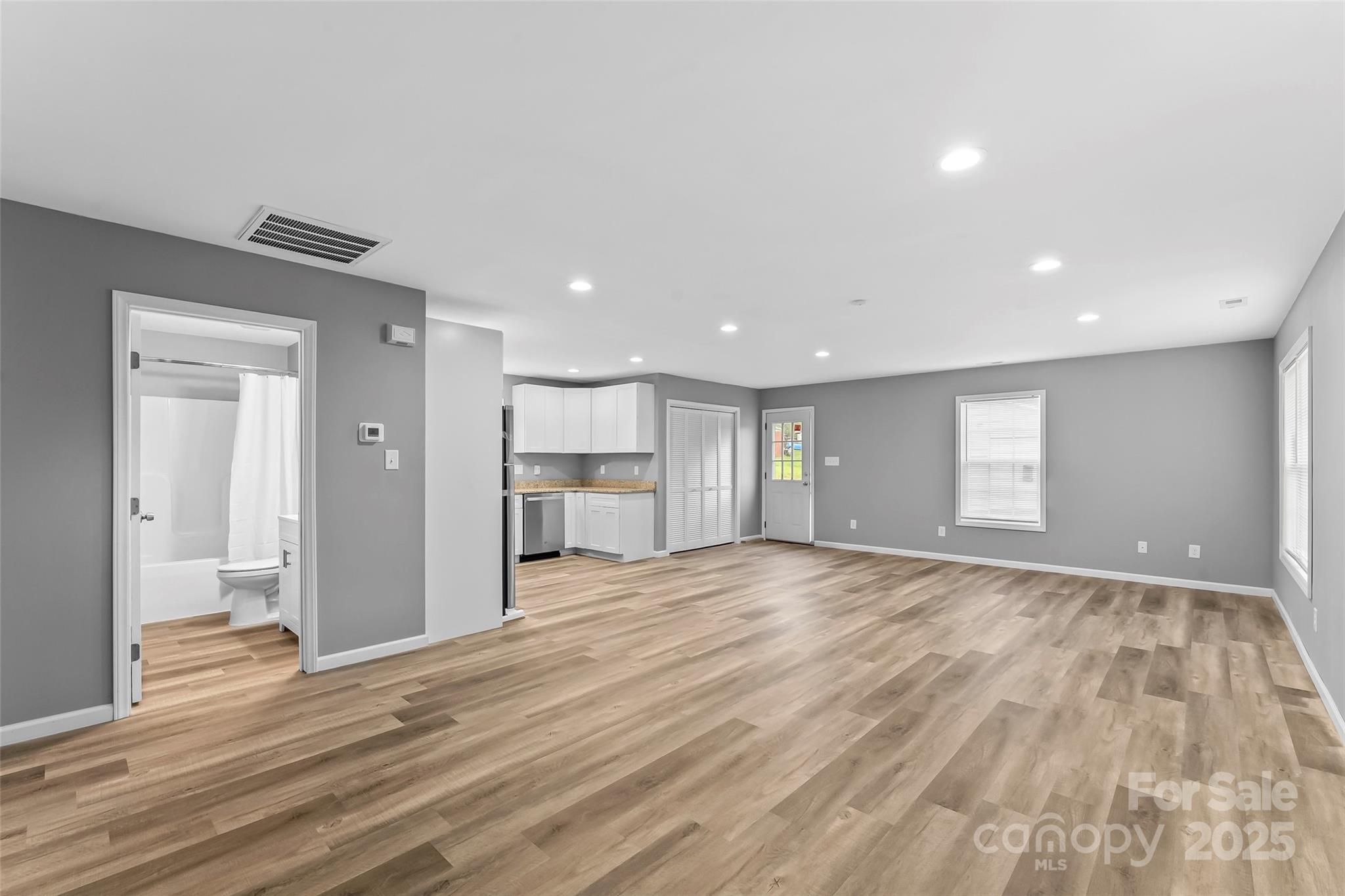 391 Springs East Road Lincolnton, NC 28092 - Photo 9 of 26 a view of empty room with wooden floor and windows