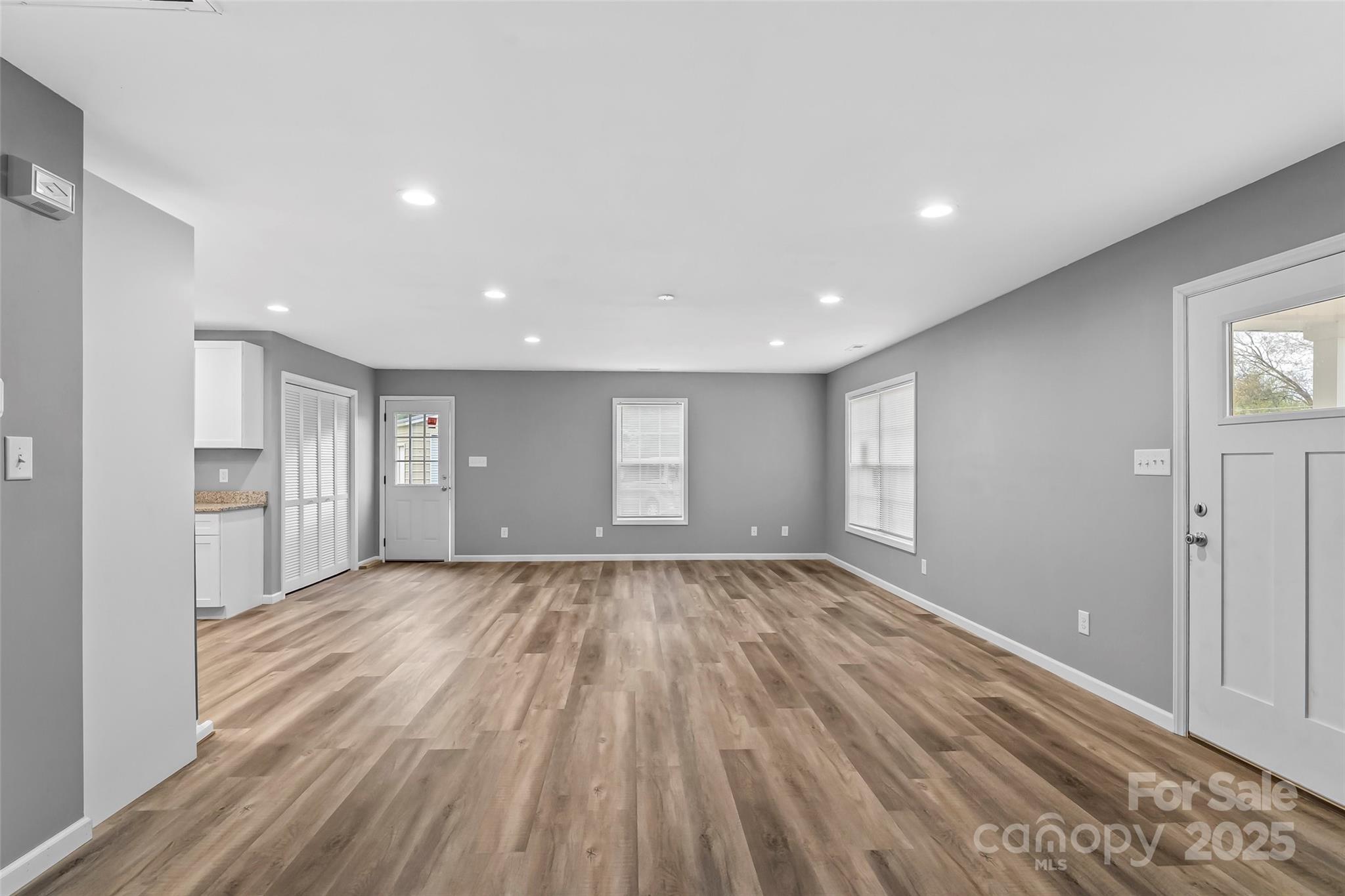 391 Springs East Road Lincolnton, NC 28092 - Photo 10 of 26 a view of an empty room with wooden floor and a window