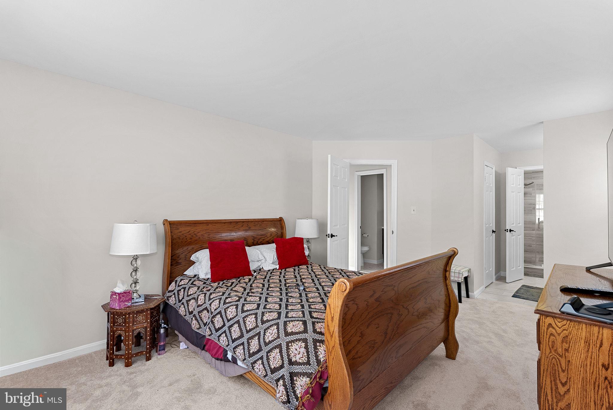 8228 Maple Ridge Avenue Springfield, VA 22153 - Photo 24 of 64 a bedroom with a bed and wooden floor