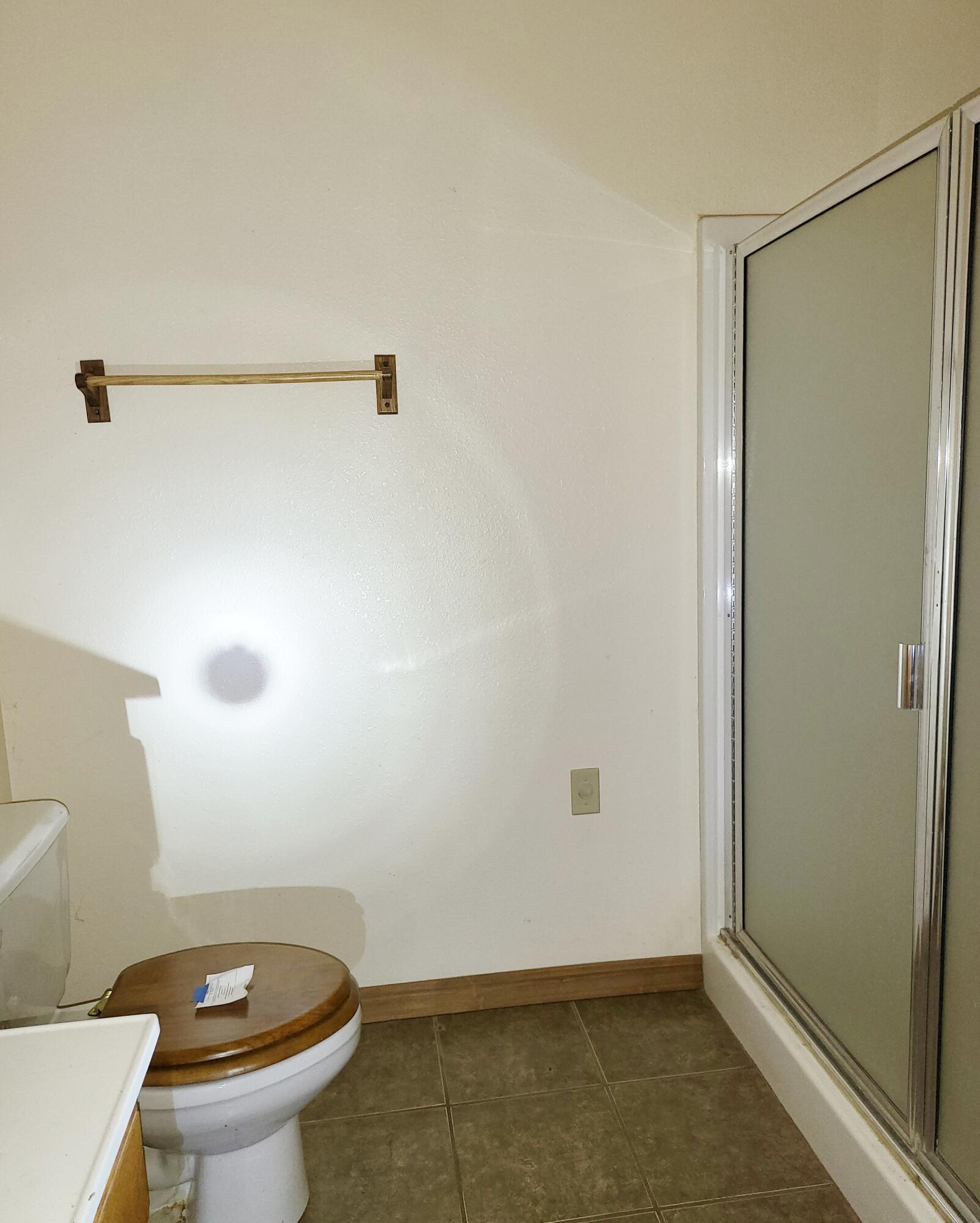 44961 Pine Shadows Road McArthur, CA 96056 - Photo 19 of 25 a bathroom with a granite countertop toilet and a shower