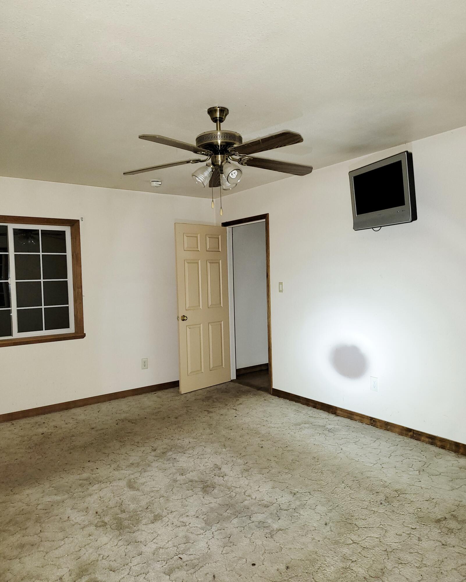 44961 Pine Shadows Road McArthur, CA 96056 - Photo 23 of 25 a view of an empty room with a window and a ceiling fan