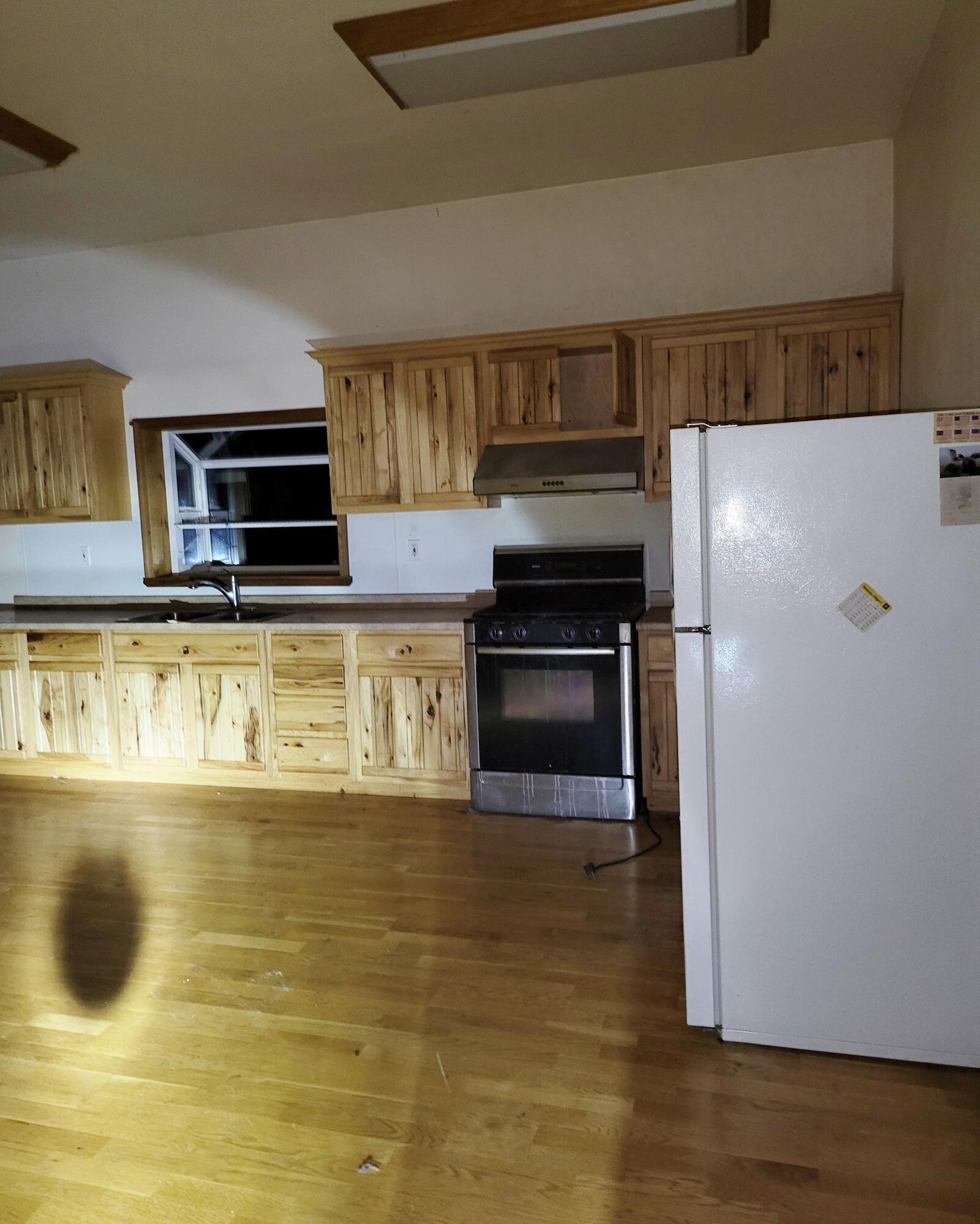 44961 Pine Shadows Road McArthur, CA 96056 - Photo 7 of 25 a kitchen with stainless steel appliances a stove a microwave and a refrigerator