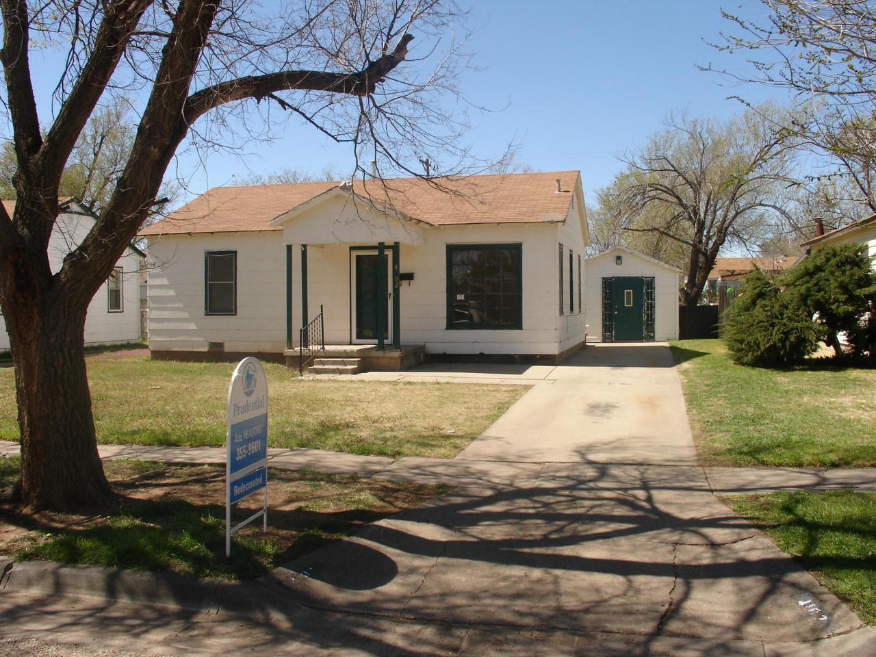 a view of a white house with a yard