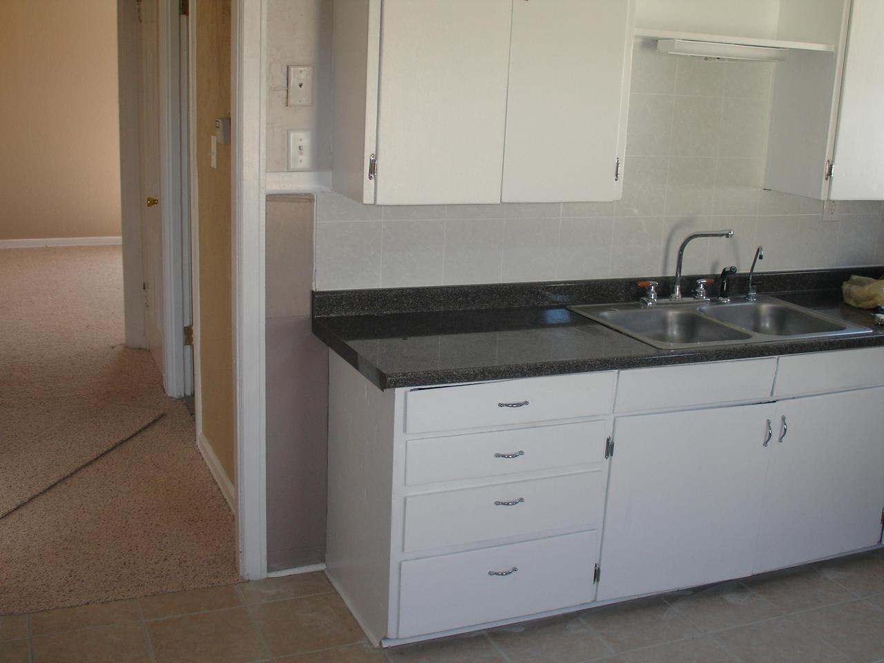 4102 South Ong Street Amarillo, TX 79110 - Photo 3 of 5 a kitchen with granite countertop white cabinets and a sink