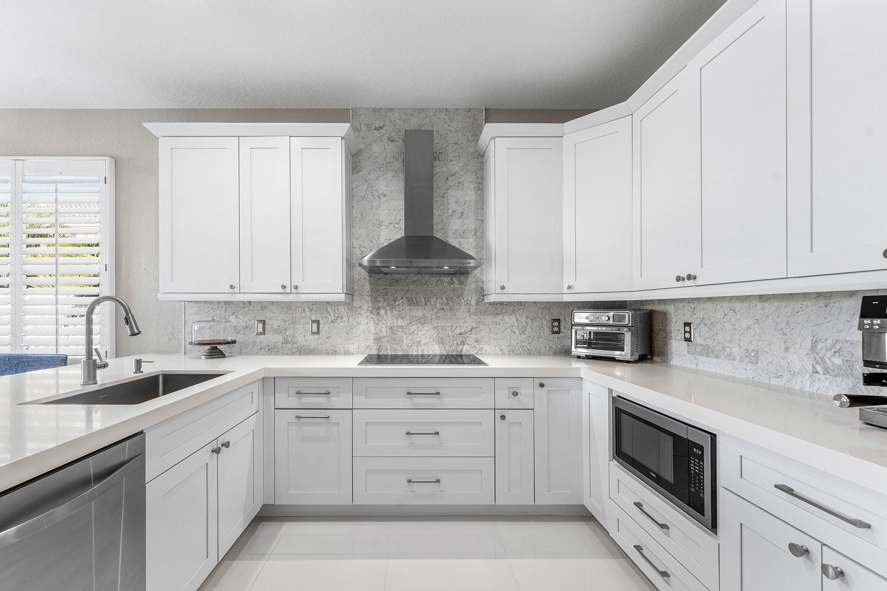 121 Palm Circle Lake Worth, FL 33462 - Photo 12 of 63 a kitchen with white cabinets appliances and a sink