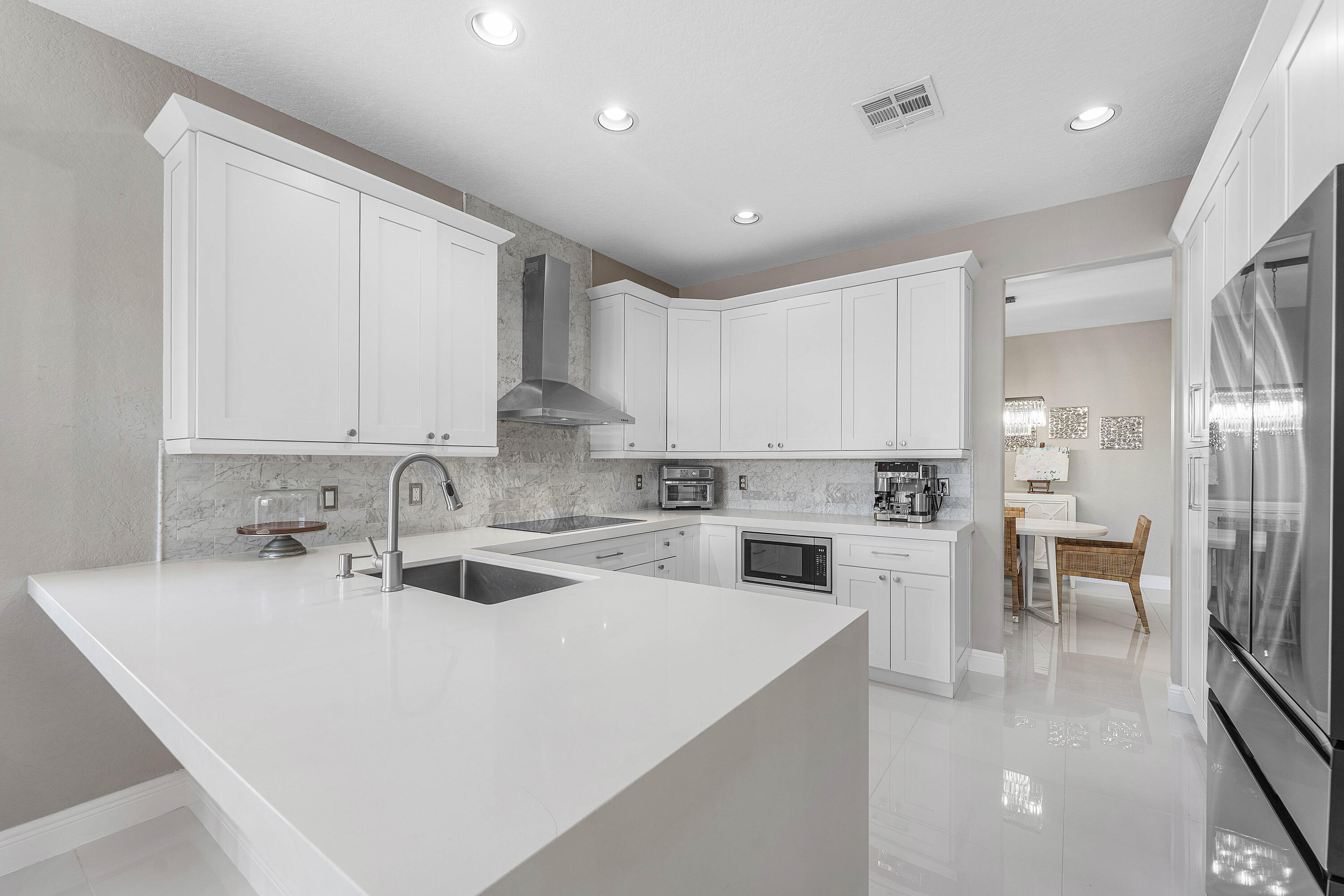 121 Palm Circle Lake Worth, FL 33462 - Photo 13 of 63 a kitchen with appliances a sink and cabinets