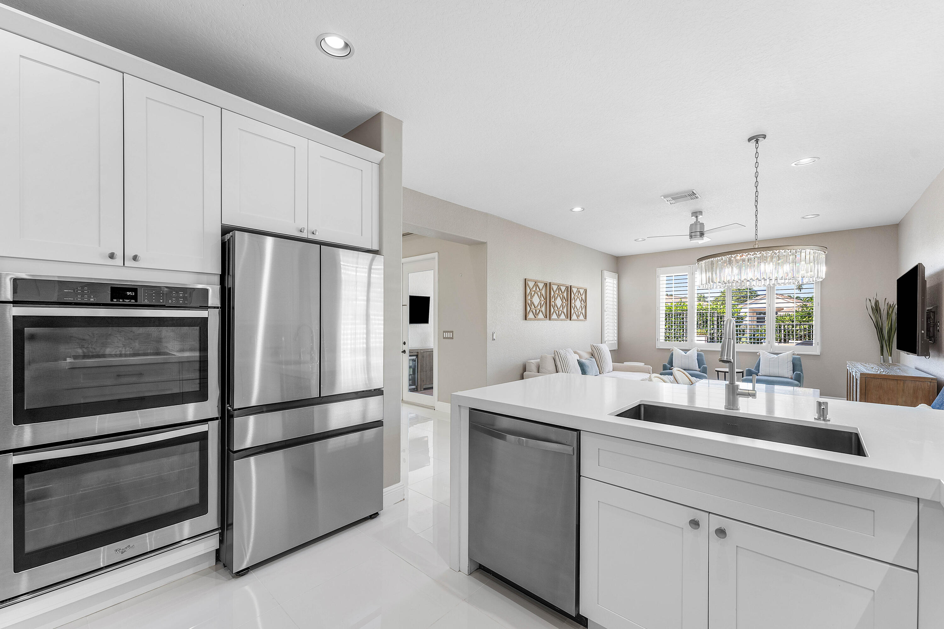 121 Palm Circle Lake Worth, FL 33462 - Photo 14 of 63 a kitchen with stainless steel appliances a refrigerator sink and cabinets