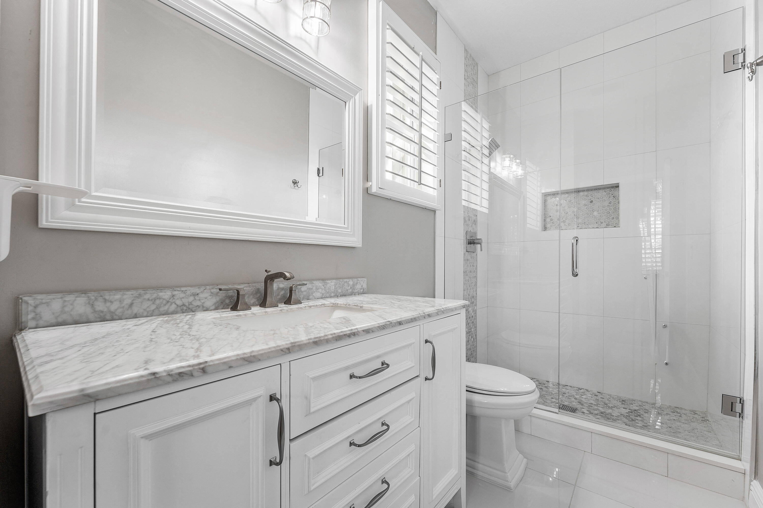 121 Palm Circle Lake Worth, FL 33462 - Photo 34 of 63 a bathroom with a granite countertop sink toilet and shower