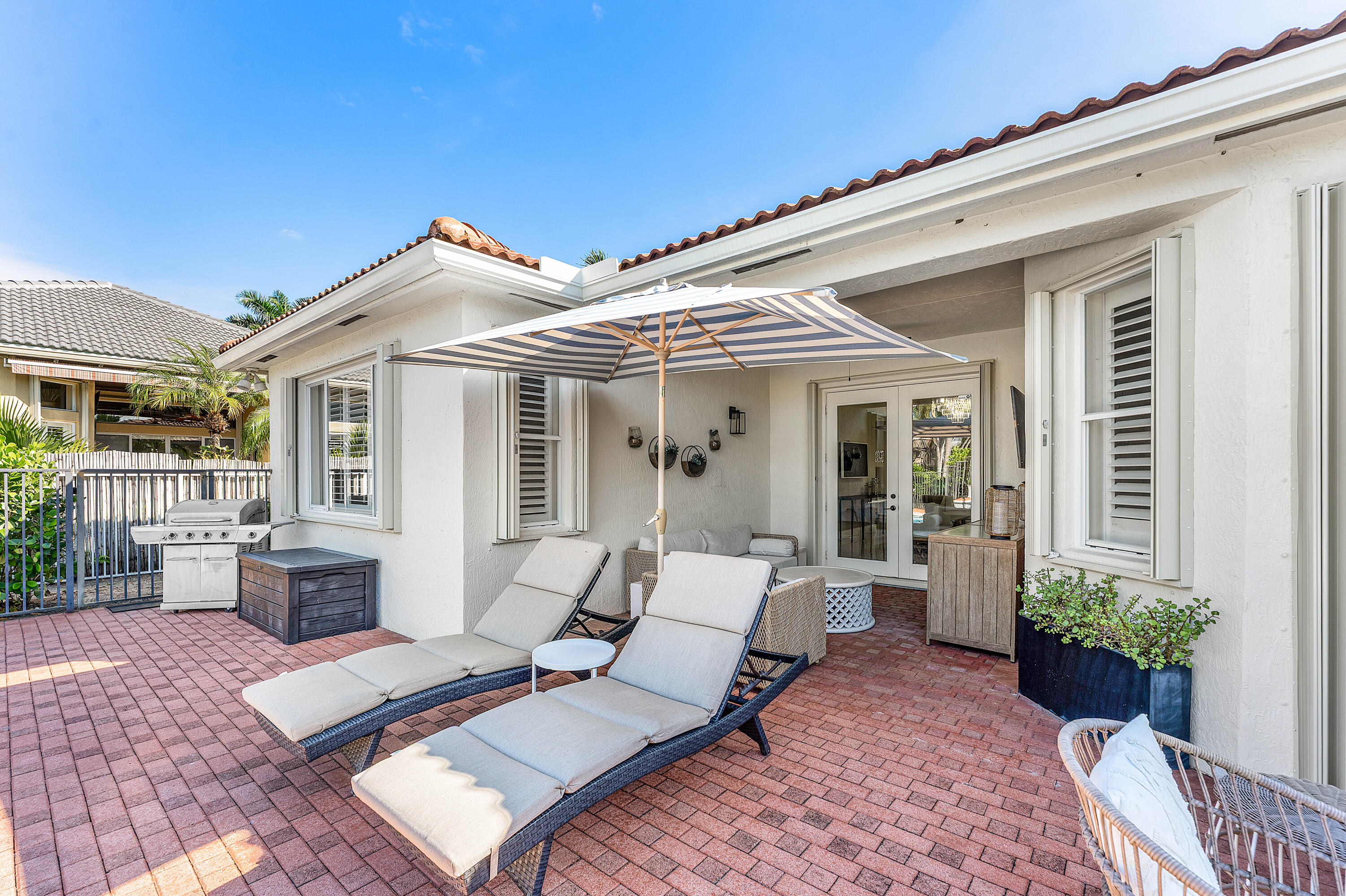 121 Palm Circle Lake Worth, FL 33462 - Photo 42 of 63 a view of a patio with couches table and chairs and potted plants