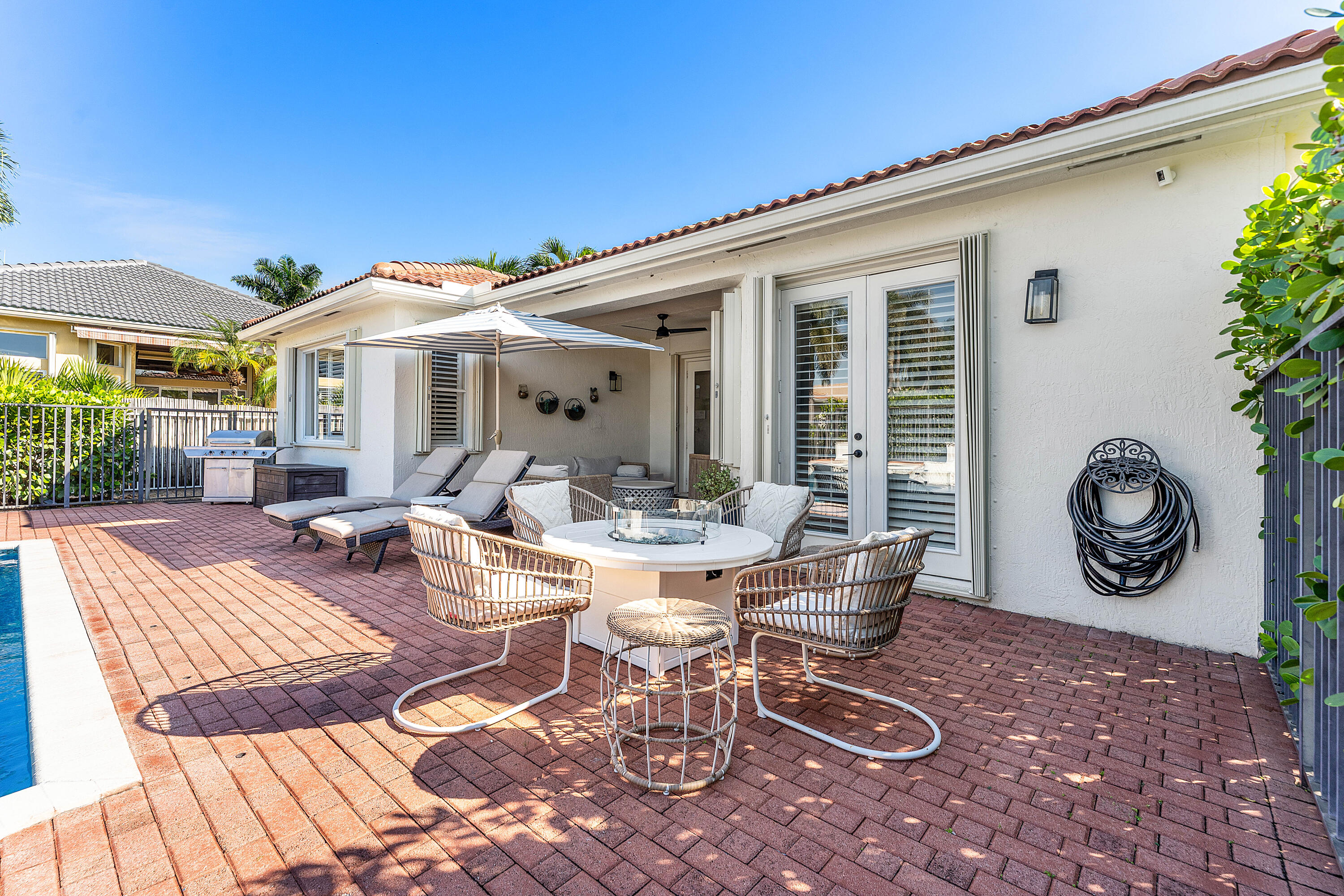 121 Palm Circle Lake Worth, FL 33462 - Photo 44 of 63 a view of a patio with table and chairs potted plants and a table