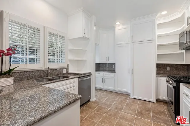 a kitchen with stainless steel appliances granite countertop a sink stove and a granite counter tops