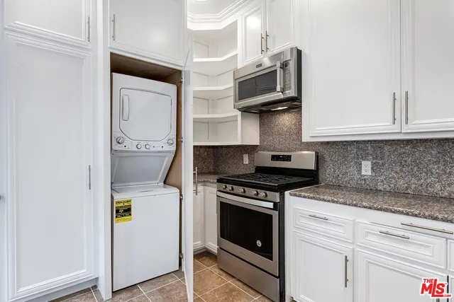 a kitchen with stainless steel appliances granite countertop a stove and a microwave