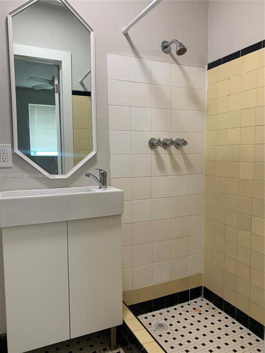 821 Southwest 29th Court, Unit 3 Miami, FL 33135 - Photo 6 of 10 a bathroom with a sink a toilet a window and shower