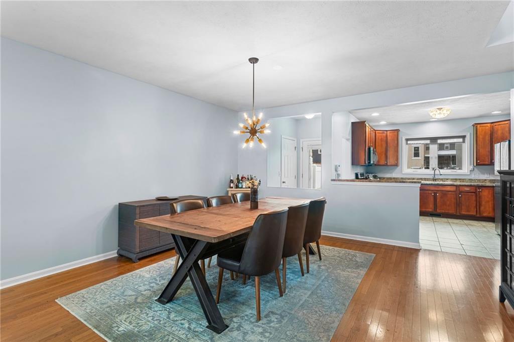 1410 Federal Street Pittsburgh, PA 15212 - Photo 12 of 42 a dining room with furniture a chandelier and wooden floor