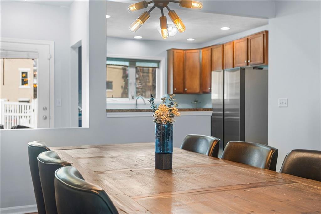 1410 Federal Street Pittsburgh, PA 15212 - Photo 13 of 42 a kitchen with stainless steel appliances kitchen island granite countertop a refrigerator a stove and a sink with wooden floor