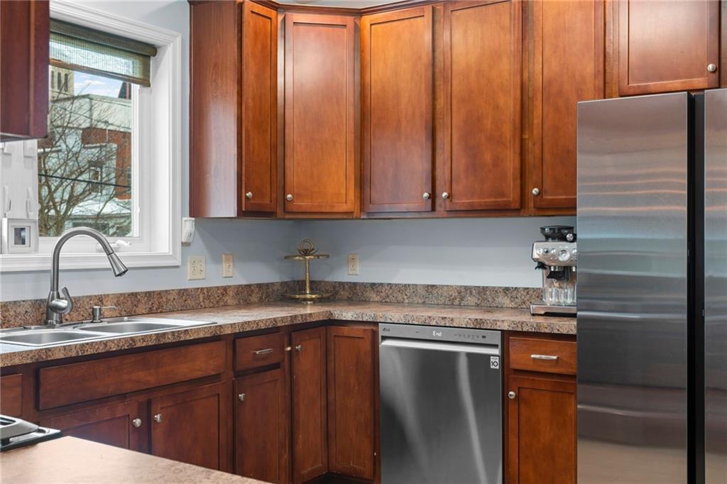 1410 Federal Street Pittsburgh, PA 15212 - Photo 16 of 42 a kitchen with granite countertop stainless steel appliances a sink window and cabinets