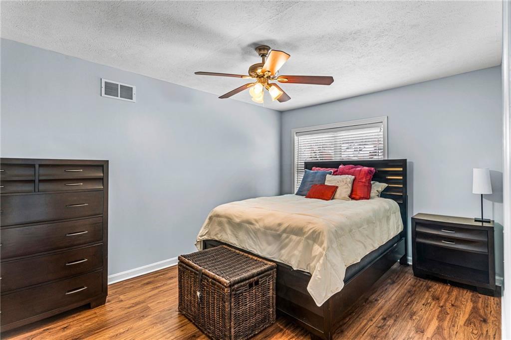 1410 Federal Street Pittsburgh, PA 15212 - Photo 27 of 42 a bedroom with a bed and a chandelier