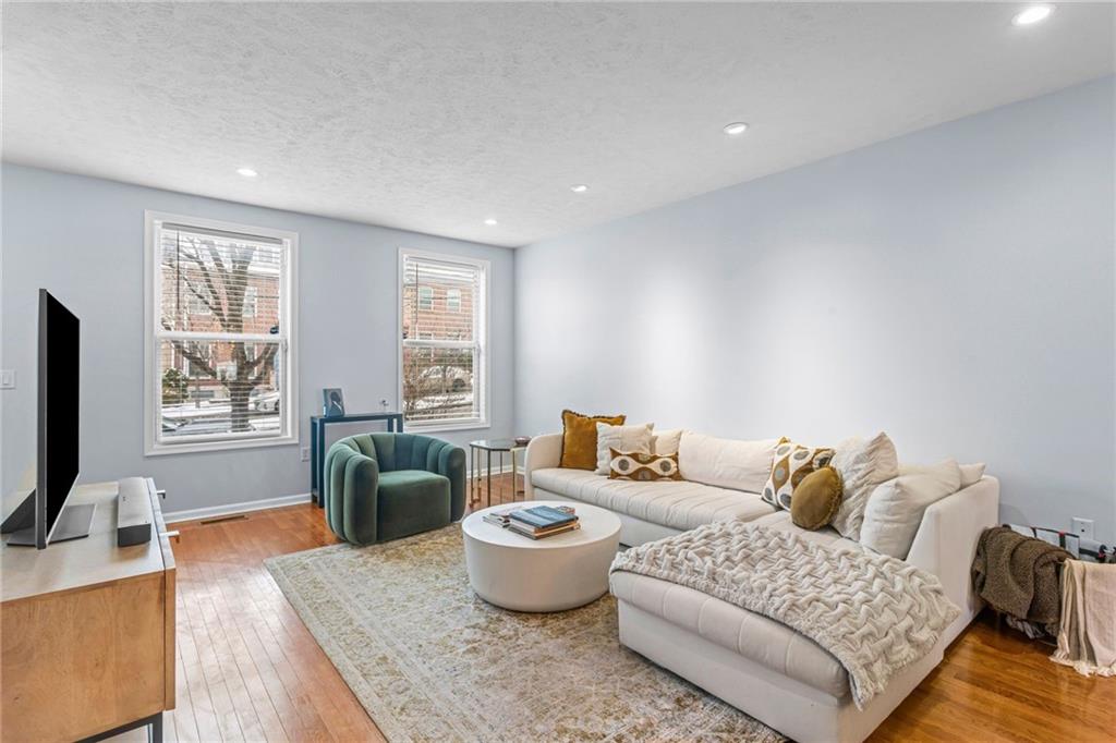 1410 Federal Street Pittsburgh, PA 15212 - Photo 4 of 42 a living room with furniture and a flat screen tv