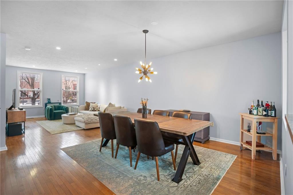 1410 Federal Street Pittsburgh, PA 15212 - Photo 7 of 42 a dining room with furniture a chandelier and wooden floor