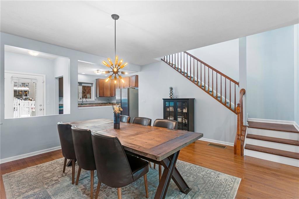 1410 Federal Street Pittsburgh, PA 15212 - Photo 8 of 42 a dining room with furniture wooden floor and a chandelier