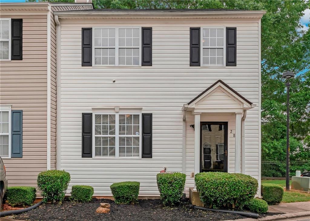 a view of a house with more windows and plants