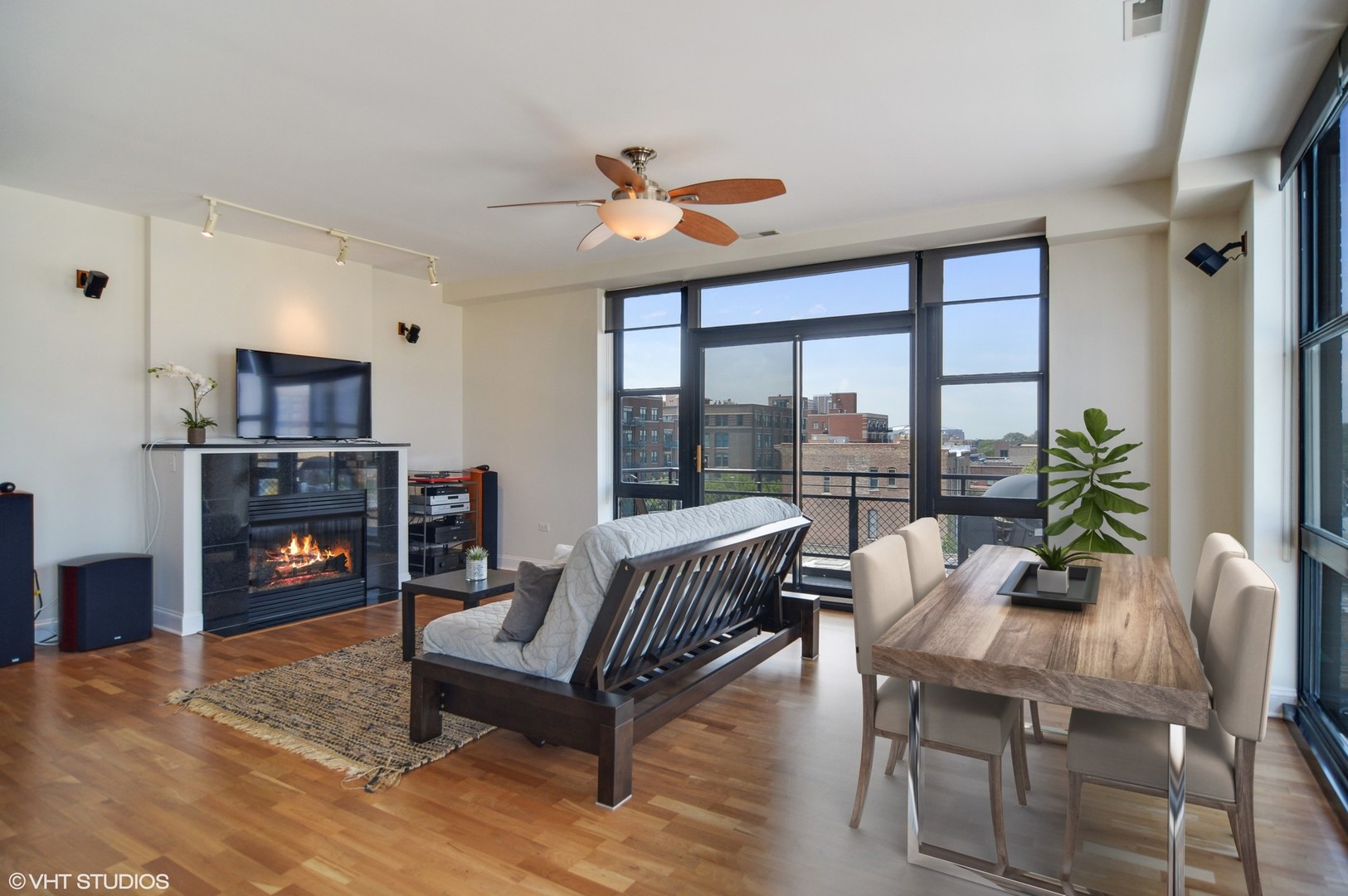 1260 West Washington Boulevard, Unit 508 Chicago, IL 60607 - Photo 3 of 10 a living room with furniture a fireplace and a floor to ceiling window