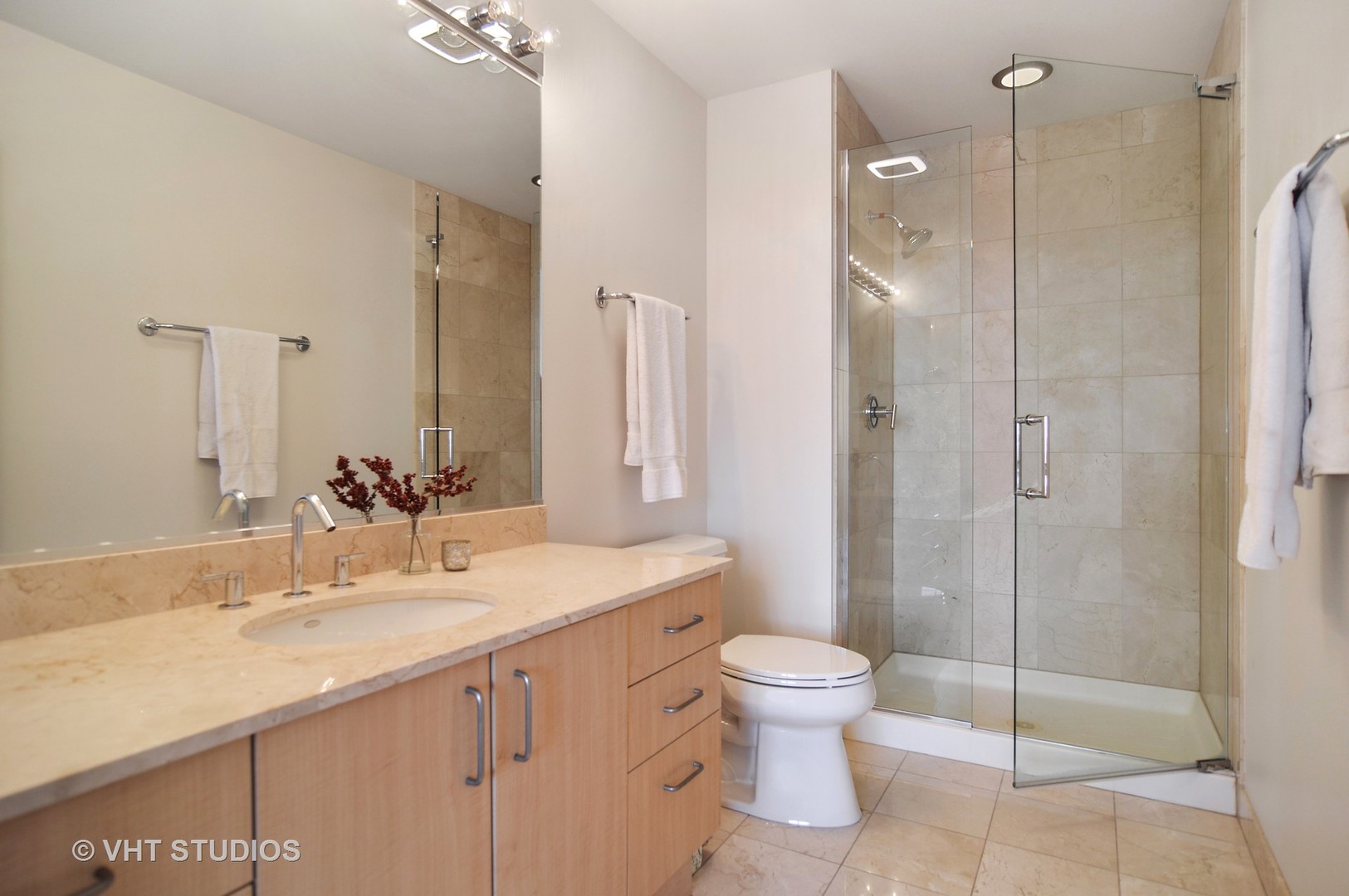 1260 West Washington Boulevard, Unit 508 Chicago, IL 60607 - Photo 7 of 10 a bathroom with a shower sink vanity mirror and toilet