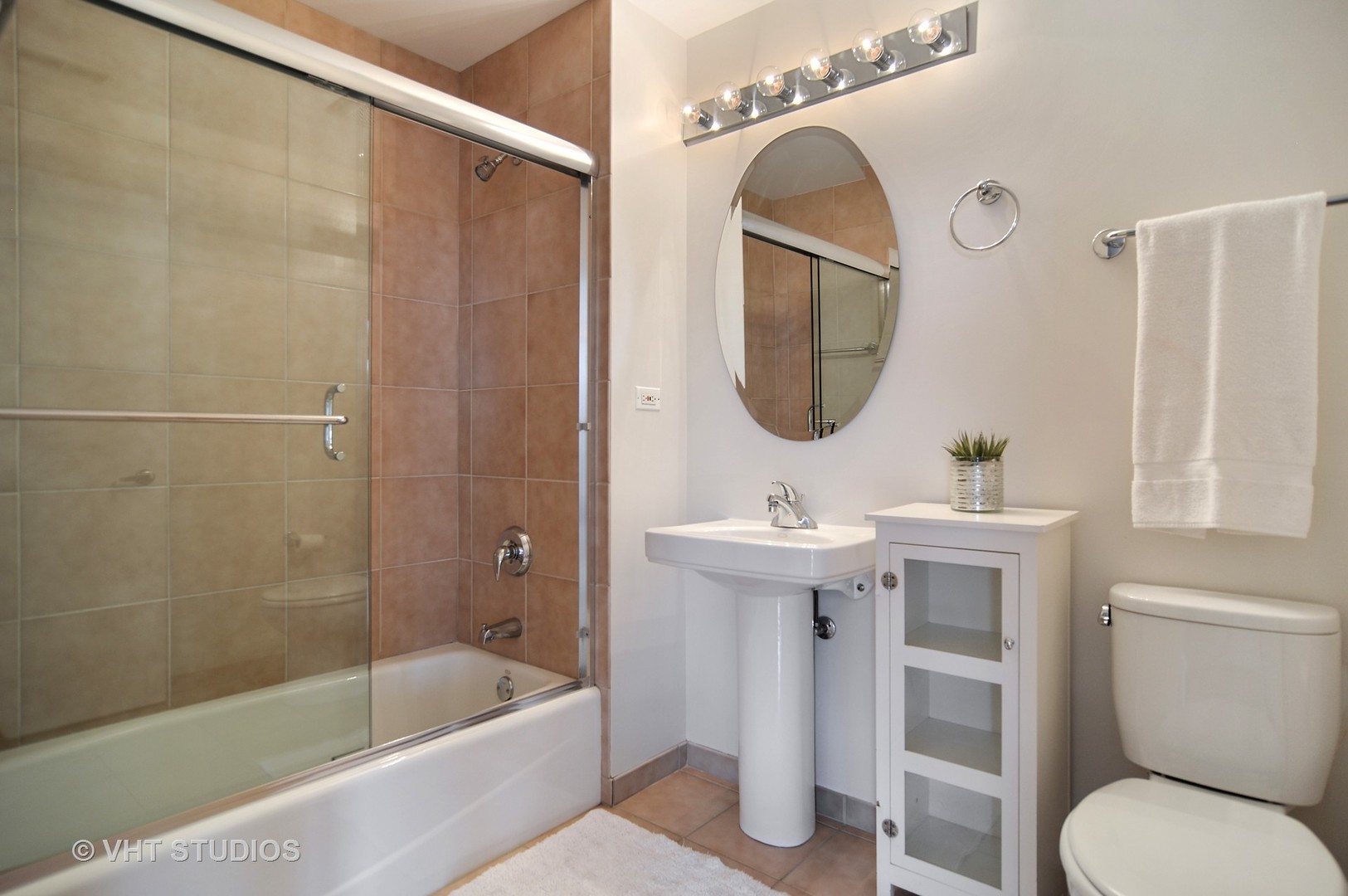 1260 West Washington Boulevard, Unit 508 Chicago, IL 60607 - Photo 9 of 10 a bathroom with a sink a toilet a mirror and shower