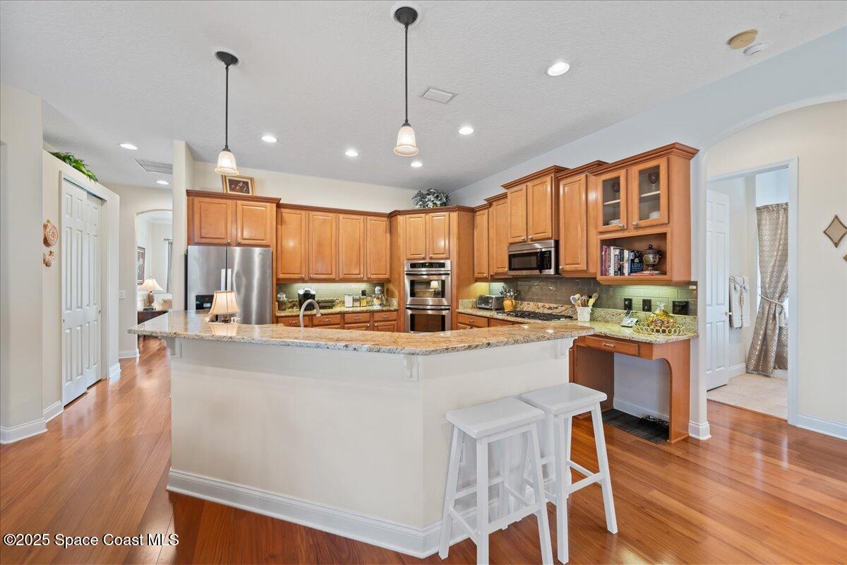 8167 Andover Way Melbourne, FL 32940 - Photo 12 of 78 a large kitchen with lots of counter space a refrigerator and a view of living room