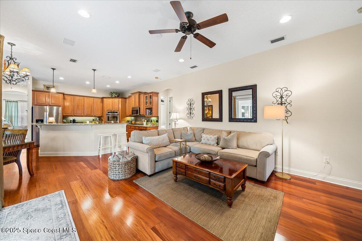 8167 Andover Way Melbourne, FL 32940 - Photo 18 of 78 a living room with furniture kitchen view and a wooden floor