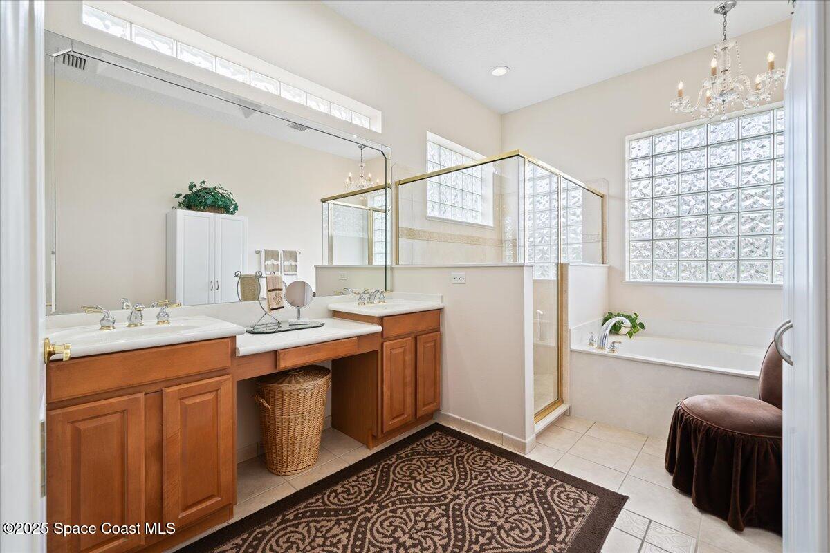 8167 Andover Way Melbourne, FL 32940 - Photo 24 of 78 a bathroom with a sink a bathtub and a shower