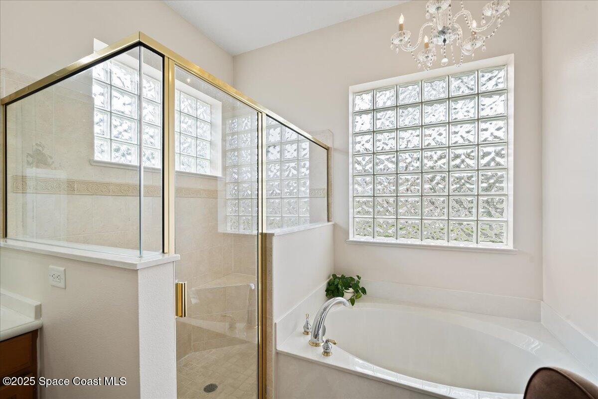 8167 Andover Way Melbourne, FL 32940 - Photo 27 of 78 a bathroom with a bathtub and window