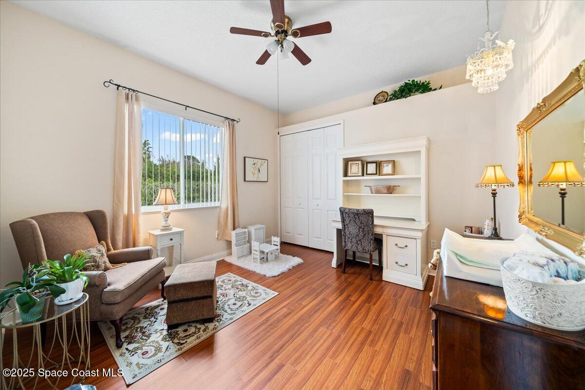 8167 Andover Way Melbourne, FL 32940 - Photo 28 of 78 a living room with furniture and wooden floor