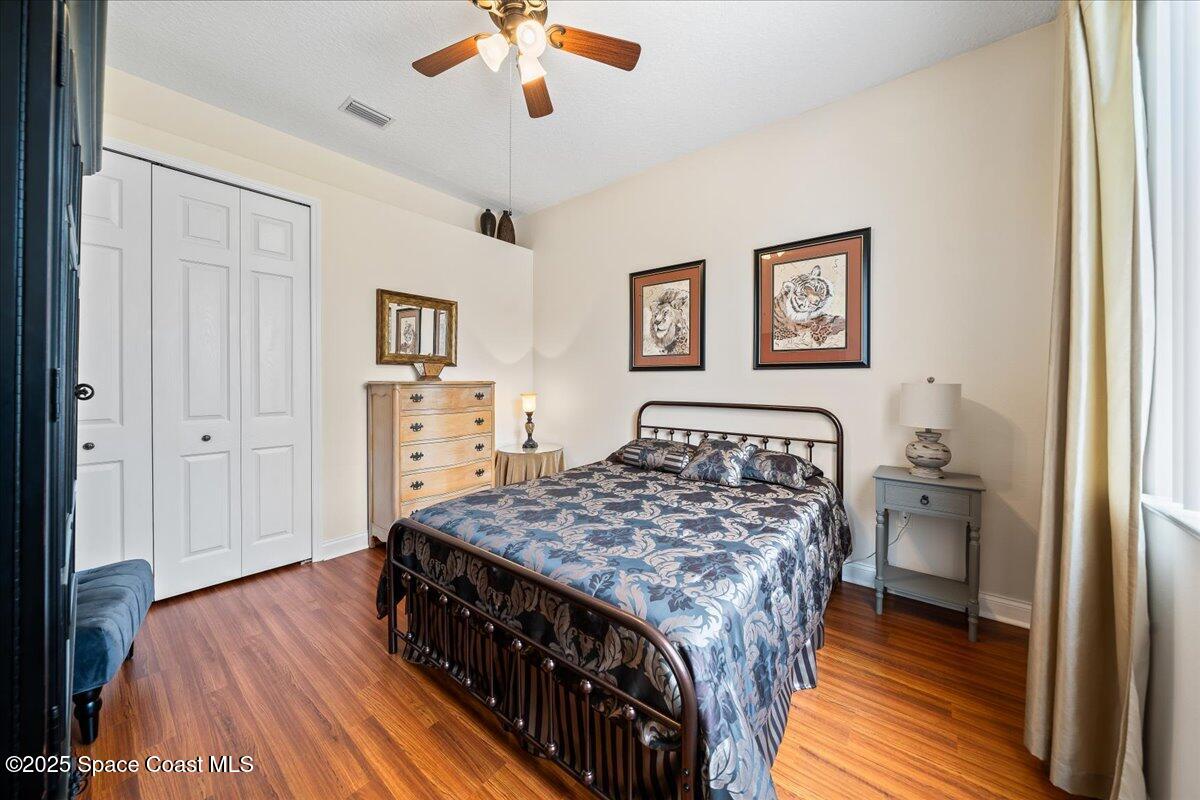 8167 Andover Way Melbourne, FL 32940 - Photo 33 of 78 a bedroom with a bed and a chandelier