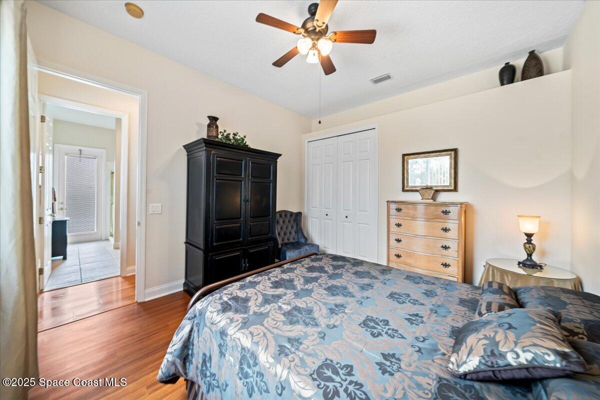 8167 Andover Way Melbourne, FL 32940 - Photo 34 of 78 a bedroom with a bed and a television