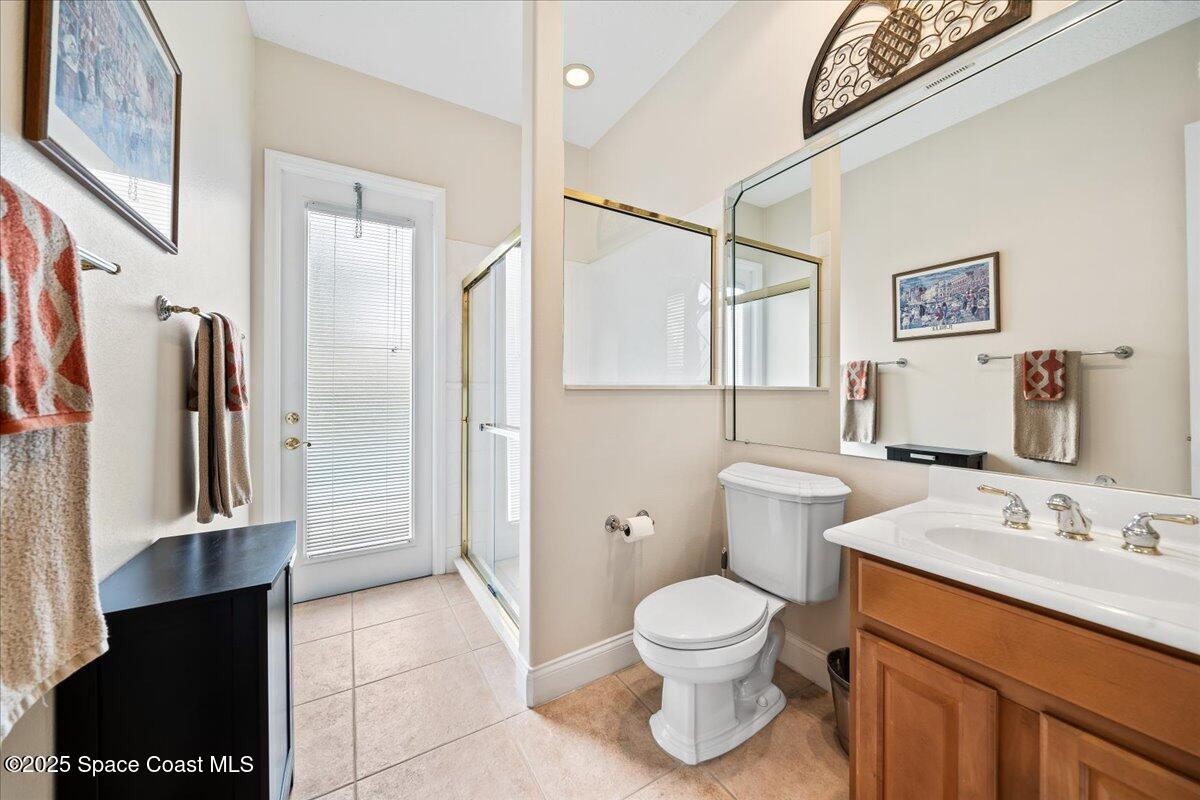 8167 Andover Way Melbourne, FL 32940 - Photo 35 of 78 a bathroom with a toilet sink and a mirror