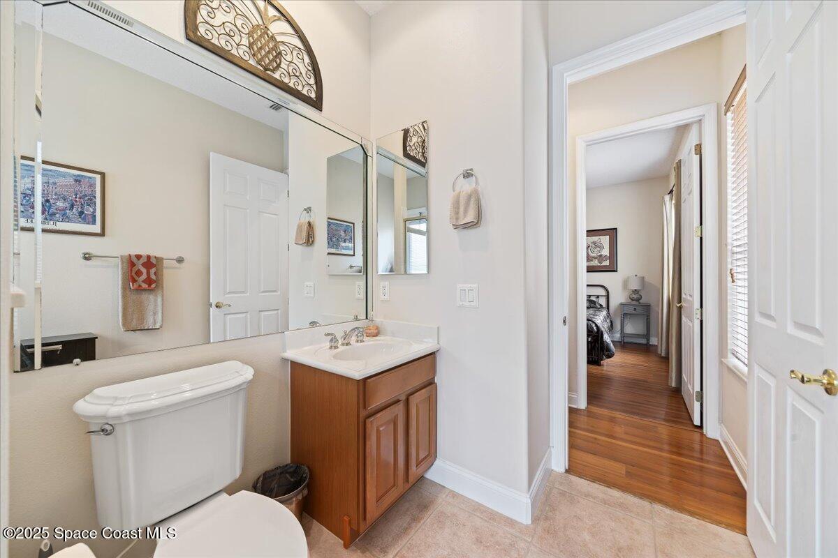 8167 Andover Way Melbourne, FL 32940 - Photo 36 of 78 a bathroom with a toilet sink and mirror
