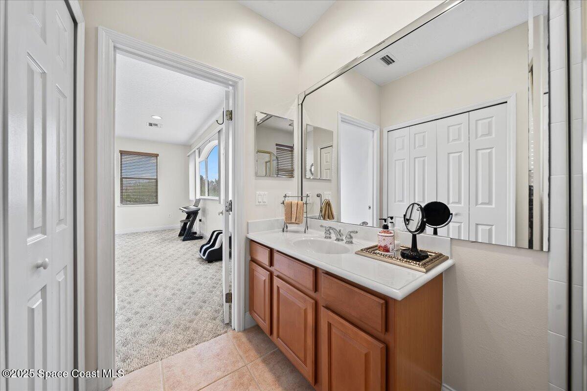 8167 Andover Way Melbourne, FL 32940 - Photo 41 of 78 a bathroom with a double vanity sink and mirror