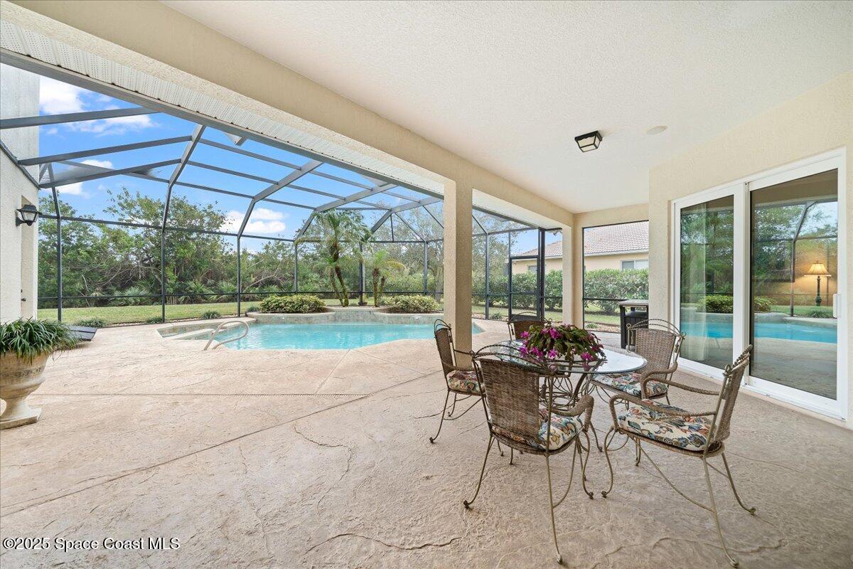 8167 Andover Way Melbourne, FL 32940 - Photo 46 of 78 a patio with yard glass top table and chairs