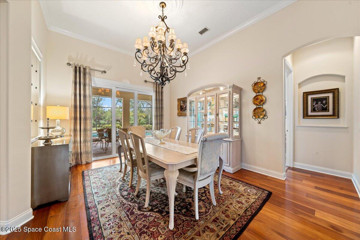 8167 Andover Way Melbourne, FL 32940 - Photo 6 of 78 a view of a dining room with furniture wooden floor and chandelier