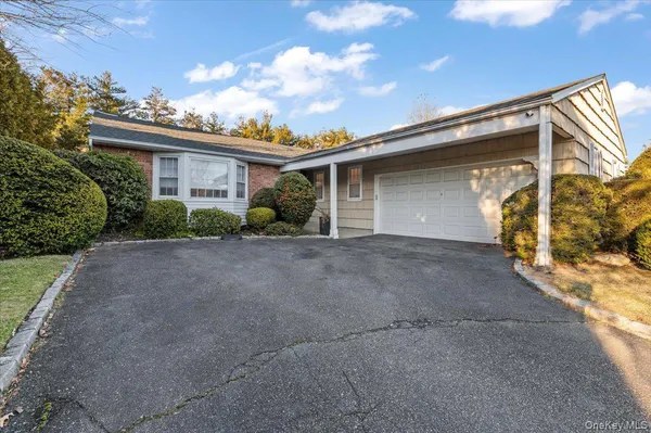 a view of a house with a yard and garage