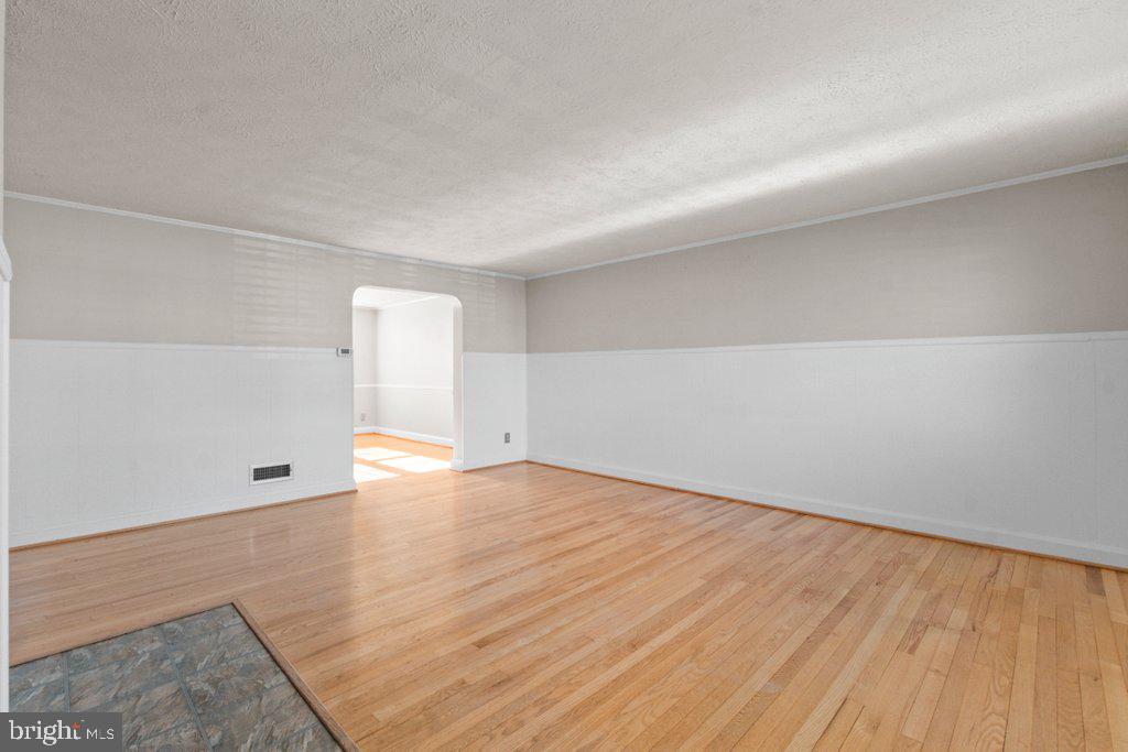 1529 Cottage Lane Towson, MD 21286 - Photo 12 of 43 an empty room with wooden floor and windows