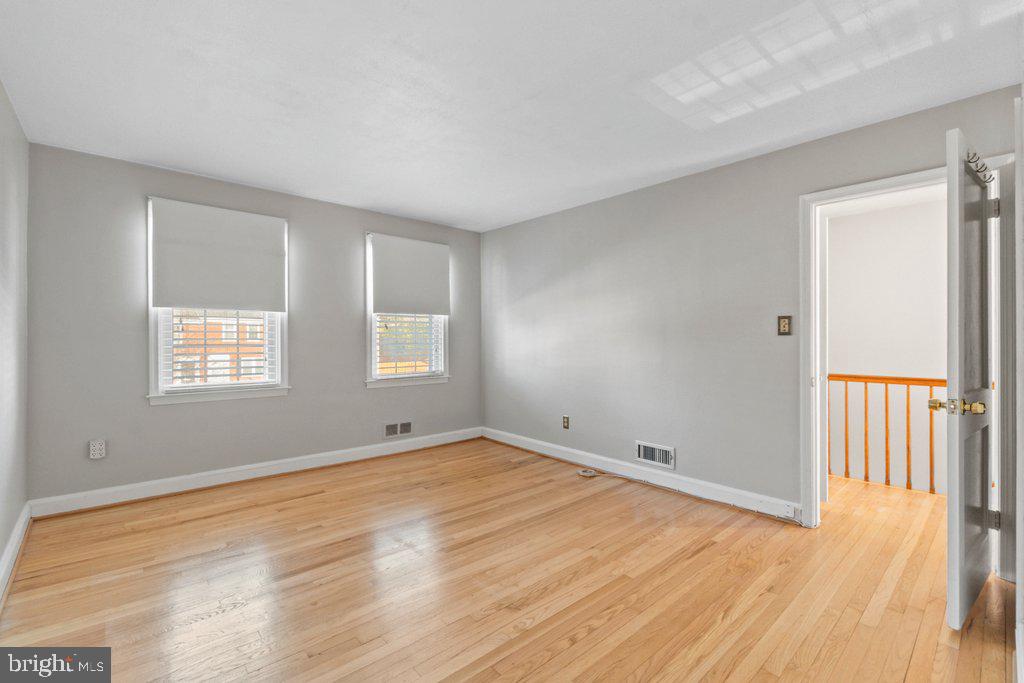 1529 Cottage Lane Towson, MD 21286 - Photo 22 of 43 a view of an empty room with wooden floor and a window