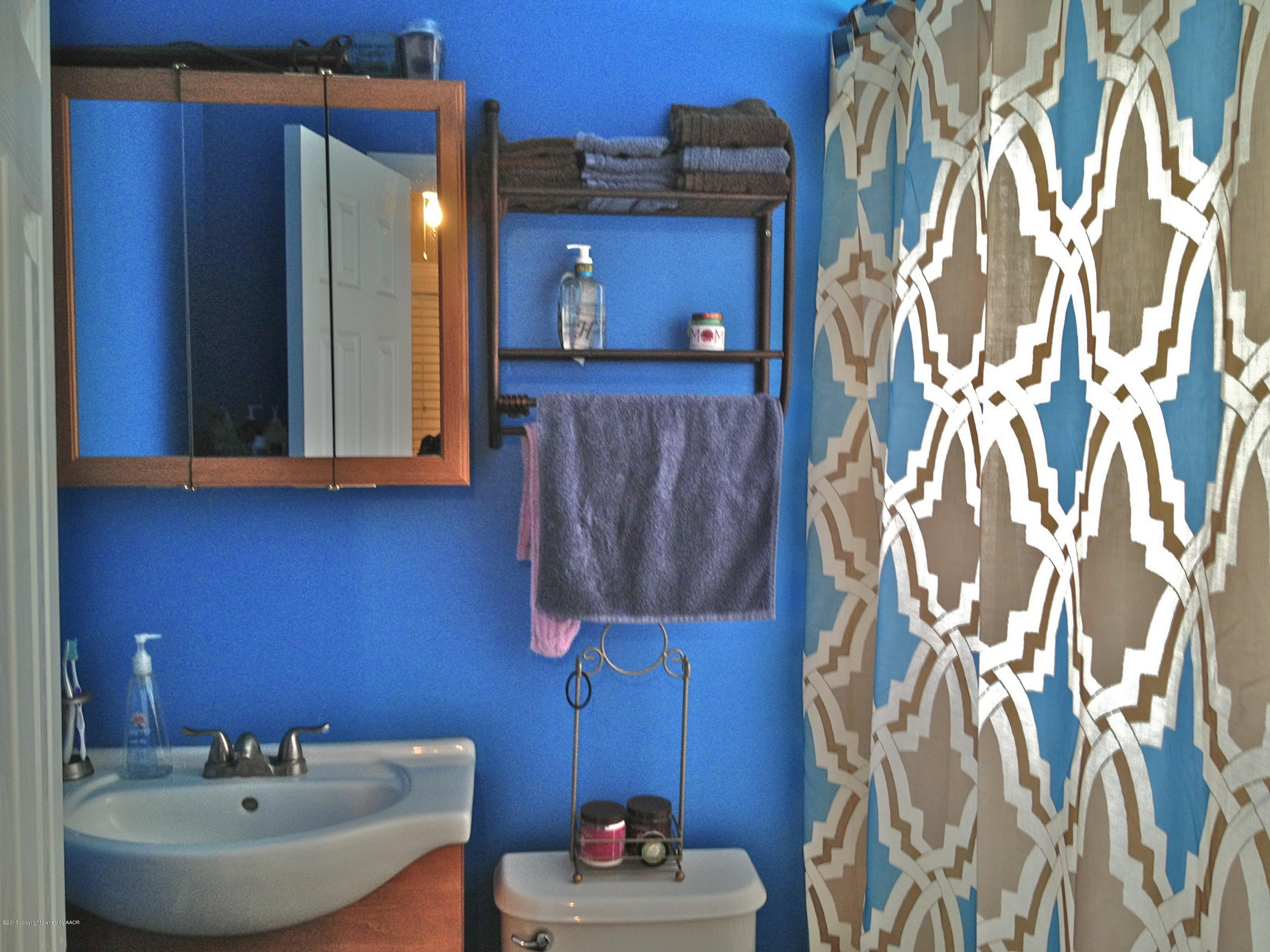 4305 South Lipscomb Street Amarillo, TX 79110 - Photo 14 of 18 a bathroom with a sink and a mirror