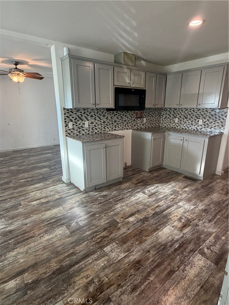 12700 Elliott, Unit 151 El Monte, CA 91732 - Photo 11 of 21 a kitchen with stainless steel appliances granite countertop a sink stove and white cabinets