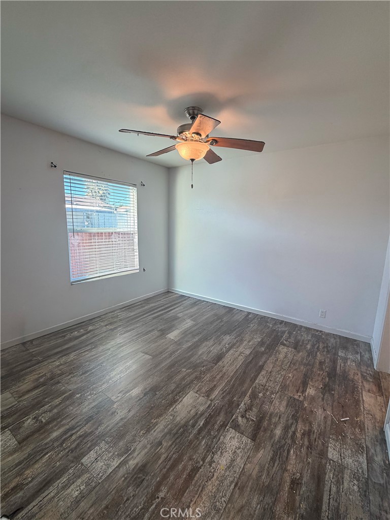 12700 Elliott, Unit 151 El Monte, CA 91732 - Photo 19 of 21 a view of a room with a ceiling fan and wooden floor