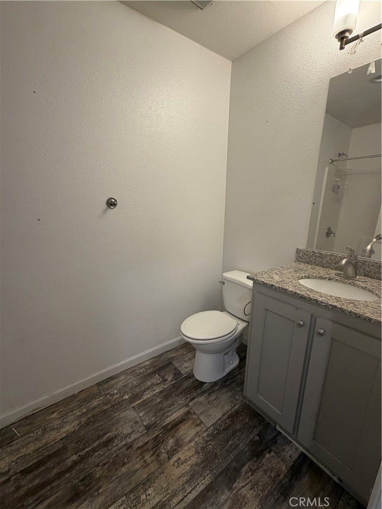 12700 Elliott, Unit 151 El Monte, CA 91732 - Photo 21 of 21 a bathroom with a granite countertop toilet and a sink