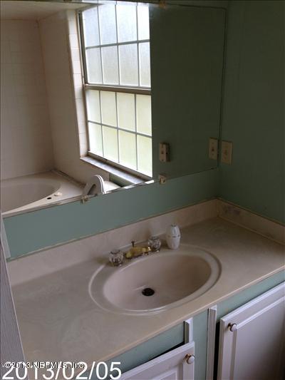832 Worth Road Jacksonville, FL 32259 - Photo 14 of 27 a bathroom with a sink and a window
