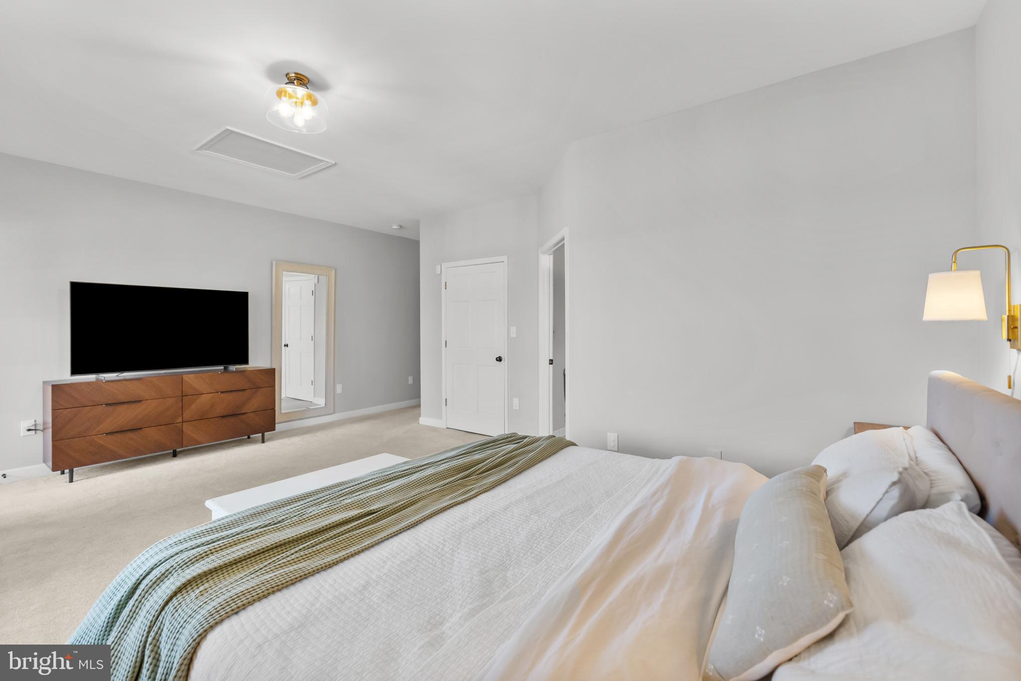 15657 Purcellville Road Purcellville, VA 20132 - Photo 26 of 72 a bedroom with a bed and a flat screen tv