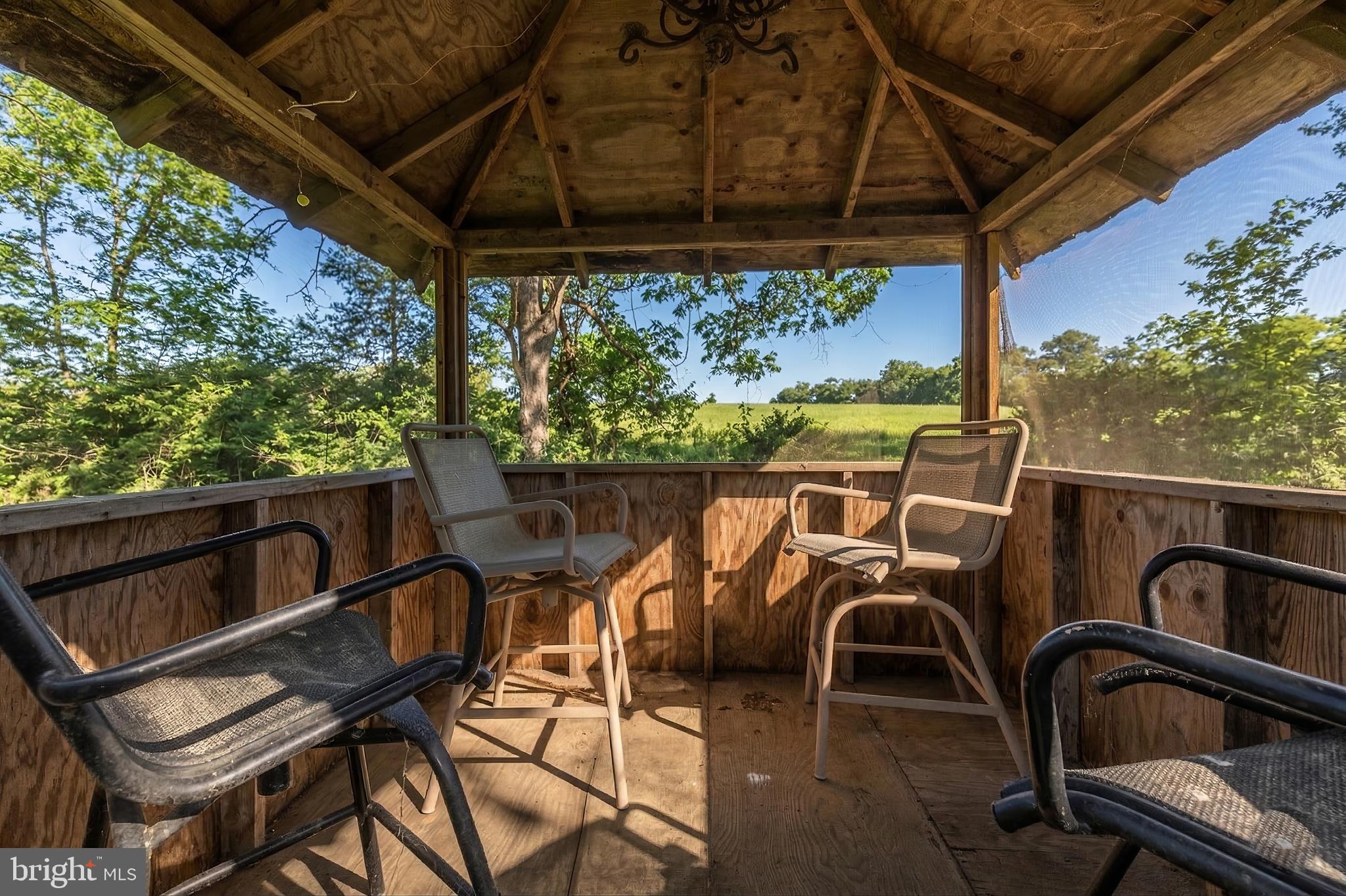15657 Purcellville Road Purcellville, VA 20132 - Photo 65 of 72 a view of a patio with table and chairs a barbeque with wooden fence